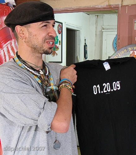 In the convenience store, an employee with a shirt showing Bush's last day in office